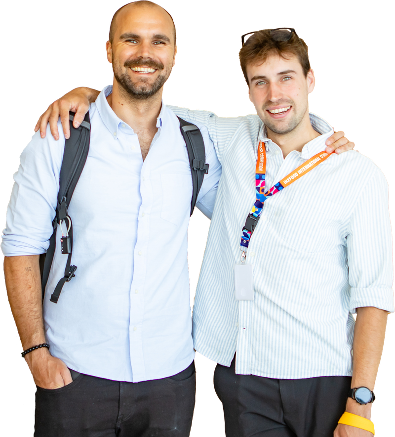 Tim Theys, arm in arm with a colleague, both smiling